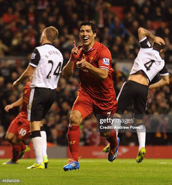 Luis Suarez of Liverpool celebrates his third goal during the Barclays Premier League match between Liverpool and Norwich City at Anfield on December...