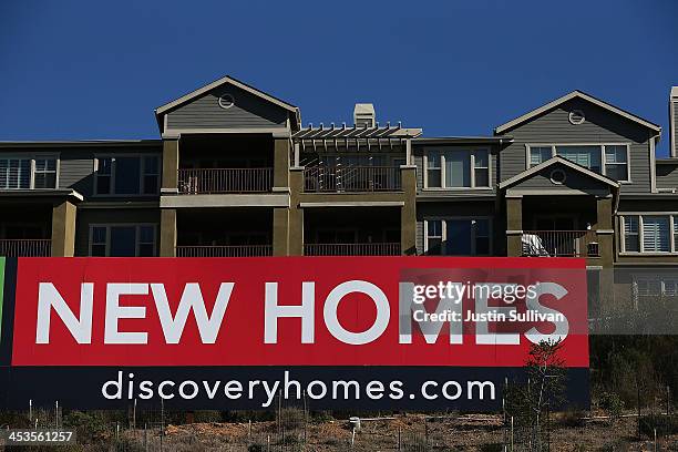 Sign advertising new homes is displayed at a housing development on December 4, 2013 in Oakland, California. According to a Commerce Department...