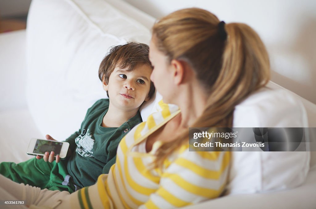 Small boy talking to his mother