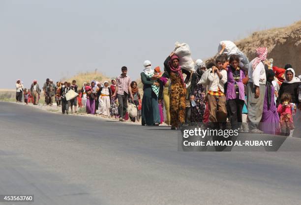 Displaced Iraqi families from the Yazidi community cross the Iraqi-Syrian border at the Fishkhabur crossing, in northern Iraq, on August 13, 2014. At...