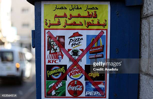 Group of Palestinians start a boycott campaign by hanging banners of Israeli products on public areas in Jerusalem on August 13, 2014.