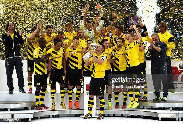 Dortmund captain Sebastian Kehl lifts the trophy following his team's 2-0 victory during the DFL Supercup between Borrussia Dortmund and FC Bayern...