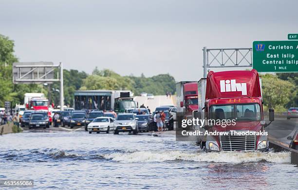 Trailer truck drives through flooded Sunrise Highway at Route 111 following heavy rains and flash flooding August 13, 2014 in Islip, New York. The...