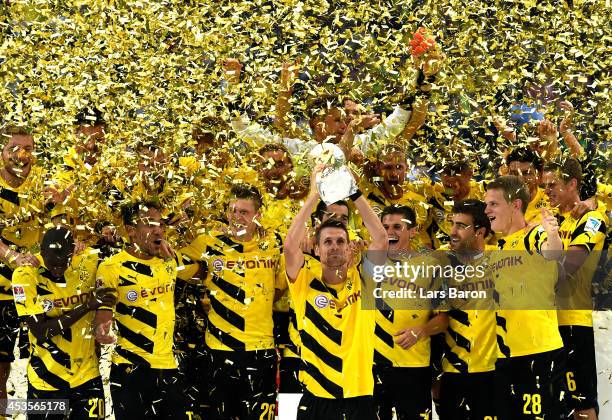 Dortmund captain Sebastian Kehl lifts the trophy following his team's 2-0 victory during the DFL Supercup between Borrussia Dortmund and FC Bayern...