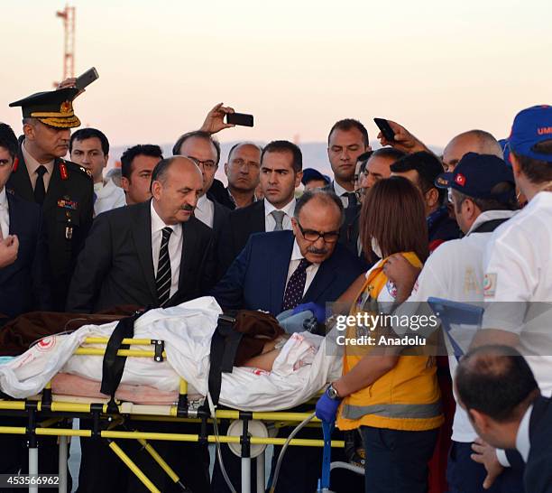 Turkey's Deputy Prime Minister Besir Atalay and Health Minister Mehmet Muezzinoglu welcome 18 Palestinians, inured during Israeli attacks in Gaza, on...