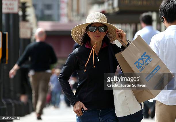 Shopper carries a bag from Ross Dress For Less on August 13, 2014 in San Francisco, California. According to a Commerce Department report, July...