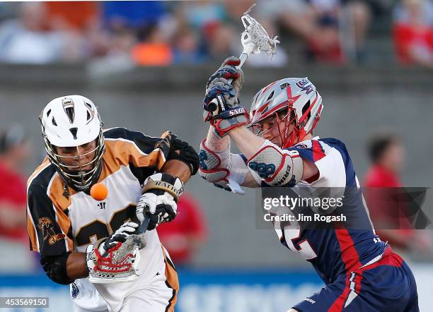 John Ortolani of the Rochester Rattlers and Craig Bunker of the Boston Cannons battle for the ball in the first period at Harvard Stadium on August...