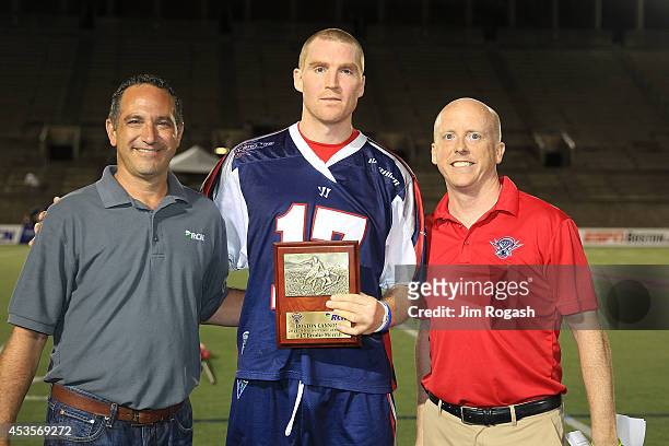Kevin Barney presents an award to Brodie Merrill of the Boston Cannons at Harvard Stadium on August 9, 2014 in Boston, Massachusetts.