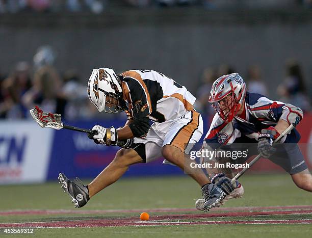 John Ortolani of the Rochester Rattlers and Craig Bunker of the Boston Cannons battle for the ball in the first period at Harvard Stadium on August...