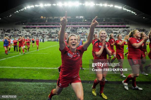 Canadian players react after winning the IRB Women's Rugby World Cup semi-final match France vs Canada at the Jean Bouin Stadium, on August 13, 2014...