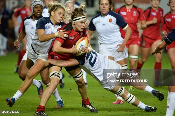 Canadian prop Marie-Pier Pinault-Reid fights with France players during the IRB Women's Rugby World Cup semi-final match between France and Canada at...