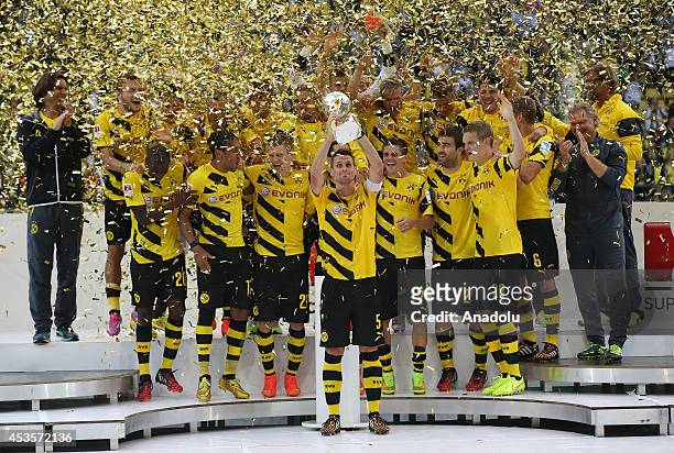 Borussia Dortmund's team celebrate their 2-0 win in the DFL Supercup 2014 match against Bayern Munich at Signal Iduna Park Stadium in Dortmund,...
