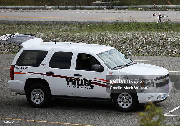An unmanned aircraft or drone hovers over a police vehicle near a simulated accident scene with chemical spill during a demonstration at Virginia...