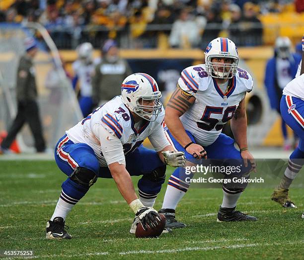 Center Eric Wood and guard Doug Legursky of the Buffalo Bills look on from the line of scrimmage during a game against the Pittsburgh Steelers at...