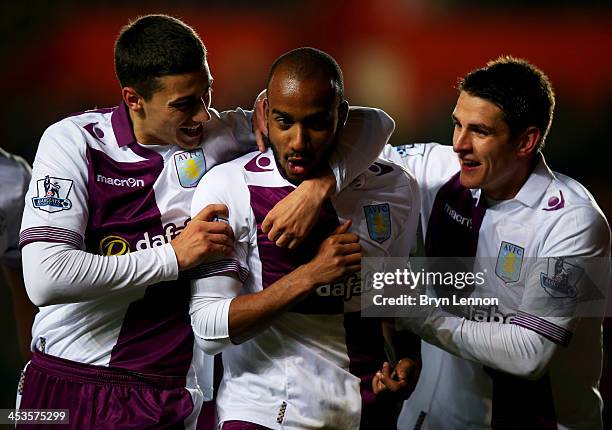 Fabian Delph of Aston Villa celebrates with team mates Matthew Lowton and Ashley Westwood as he scores their third goal during the Barclays Premier...