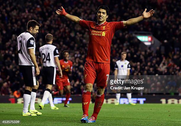 Luis Suarez of Liverpool celebrates setting up the fifth goal for team mate Raheem Sterling during the Barclays Premier League match between...