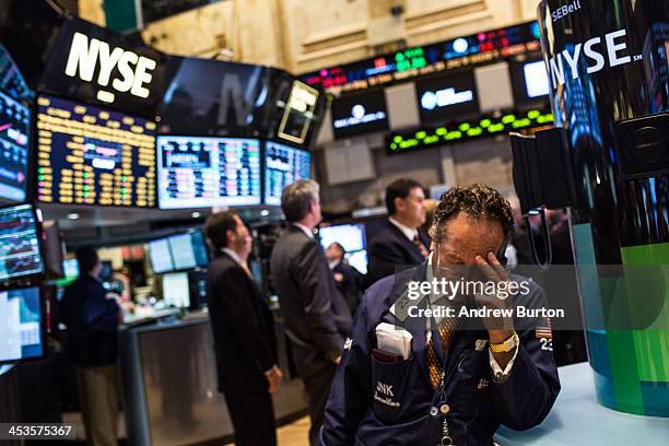 Trader works on the floor of the New York Stock Exchange on December 4, 2013 in New York City. The Dow Jones Industrial Average dipped over 100...