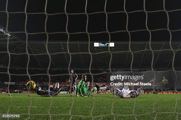 Jonjo Shelvey of Swansea City looks back with Tim Krul of Newcastle as the ball rebounds off Mike Williamson into the net for the second goal during...