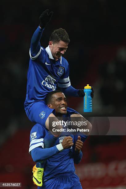 Bryan Oviedo and Sylvain Distin of Everton celebrate after during the Barclays Premier League match between Manchester United and Everton at Old...