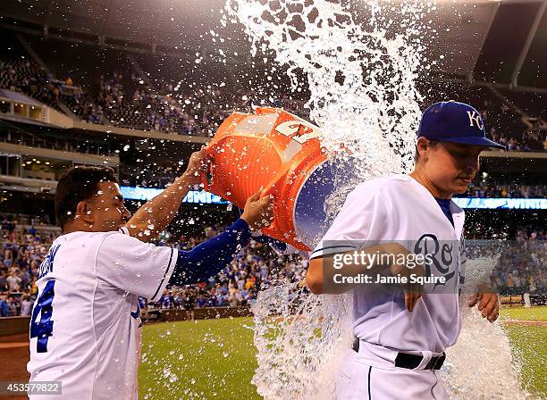 Starting pitcher Jason Vargas of the Kansas City Royals receives a water dunk from Christian Colon and Salvador Perez after pitching a complete game...