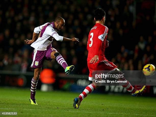 Fabian Delph of Aston Villa shoots past Maya Yoshida of Southampton to score their third goal during the Barclays Premier League match between...