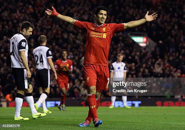 Luis Suarez celebrates the goal of team mate Raheem Sterling during the Barclays Premier League match between Liverpool and Norwich City at Anfield...