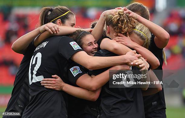 New Zealand players, with Evie Millynn centre, celebrate the goal of Tanya O'Brien the FIFA U-20 Women's World Cup Canada 2014 Group D match between...