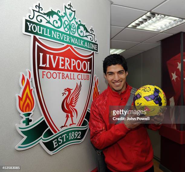Luis Suarez of Liverpool celebrates with the hat trick ball after the Barclays Premier League match between Liverpool and Norwich City at Anfield on...