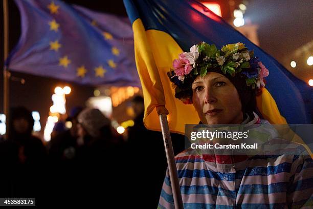 Protester holds a Ukrainian national flag as anti-government protesters rally in Independence Square on December 4, 2013 in Kiev, Ukraine. Thousands...