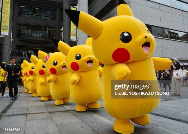 Dozens of Pikachu characters, the famous character of Nintendo's videogame software Pokemon, parade at the Landmark Plaza shopping mall in Yokohama,...