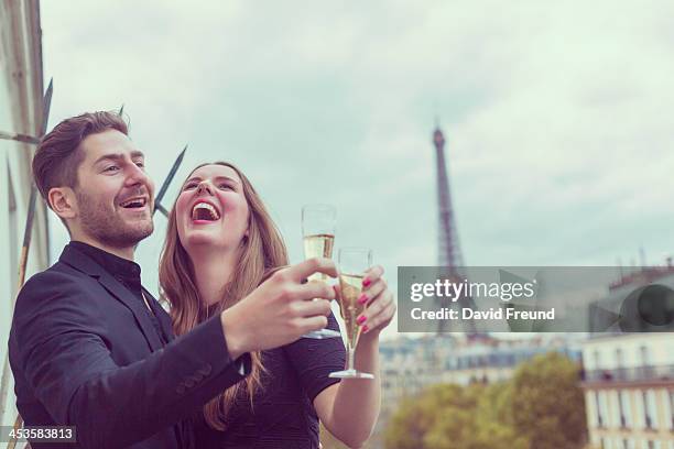 young well dressed couple celebrating in paris - champagne tower stock pictures, royalty-free photos & images