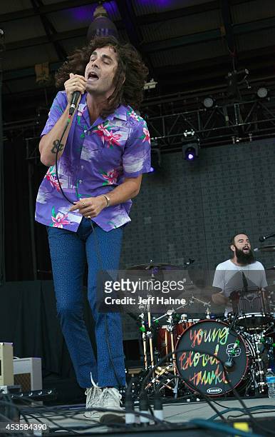 Youngblood Hawke singer Sam Martin and drummer Nik Hughes perform in concert at the Uptown Amphitheatre on August 13, 2014 in Charlotte, North...