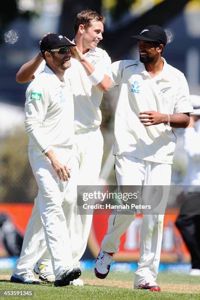 Tim Southee of New Zealand celebrates the wicket of Narsingh Deonarine of the West Indies with Aaron Redmond and Ish Sodhi during day three of the...