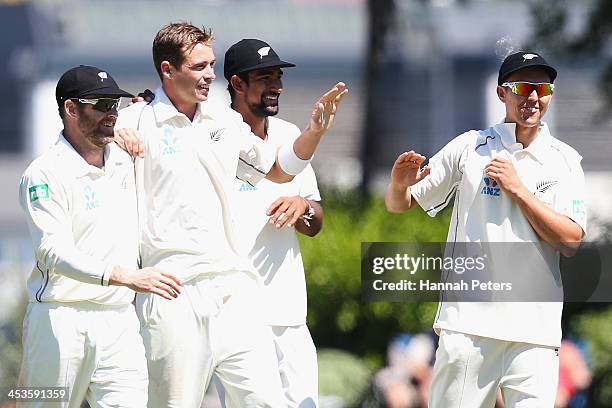 Tim Southee of New Zealand celebrates the wicket of Narsingh Deonarine of the West Indies with Aaron Redmond, Ish Sodhi and Trent Boult during day...