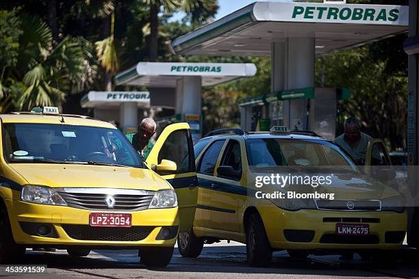 Taxi drivers fill the tanks of their vehicles with natural gas at a Petroleo Brasileiro SA fueling station in Rio de Janeiro, Brazil, on Wednesday,...