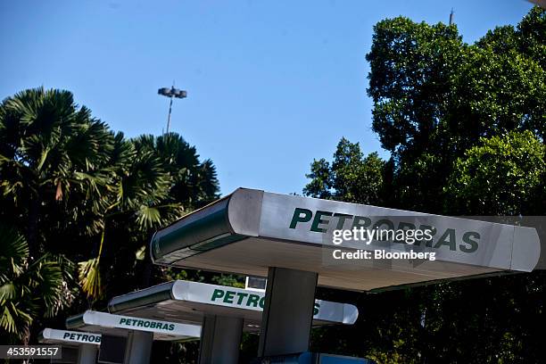 Petroleo Brasileiro SA signage stands outside of a fueling station in Rio de Janeiro, Brazil, on Wednesday, Dec. 4, 2013. Petroleo Brasileiro SA's...