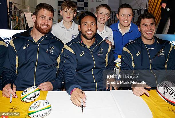 James Horwill, Christian Lealiifano and Tom English pose with young fans during the Bledisloe Cup Fan Day at Fleet Park, Circular Quay on August 14,...