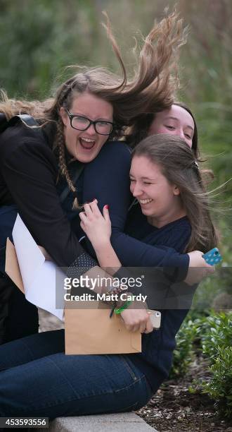 Ellie Wood, who got two grade A's and a A* and is taking a place at Cambridge is congratulated by her friends Melissa Fox-Robinson and Clare Hemmings...