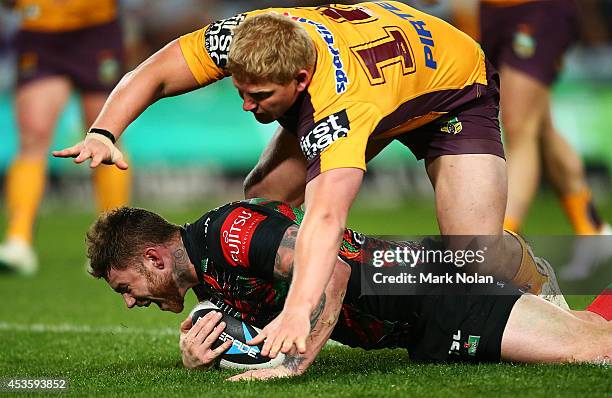 Chris McQueen of the Rabbitohs celebrates scoring a try during the round 23 NRL match between the South Sydney Rabbitohs and the Brisbane Broncos at...