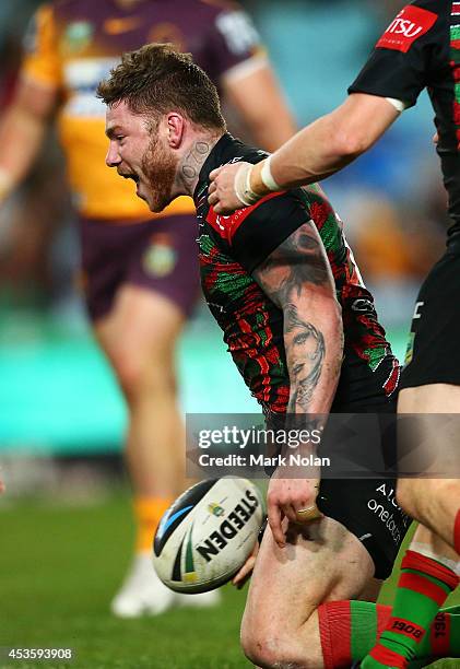 Chris McQueen of the Rabbitohs celebrates scoring a try during the round 23 NRL match between the South Sydney Rabbitohs and the Brisbane Broncos at...