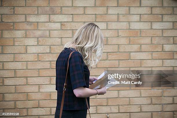 Students at the Winterbourne International Academy react as they open their A-level results on August 14, 2014 in South Gloucestershire, near...