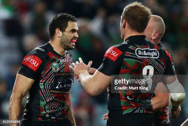 Greg Inglis of the Rabbitohs celebrates with team mates after scoring a try during the round 23 NRL match between the South Sydney Rabbitohs and the...