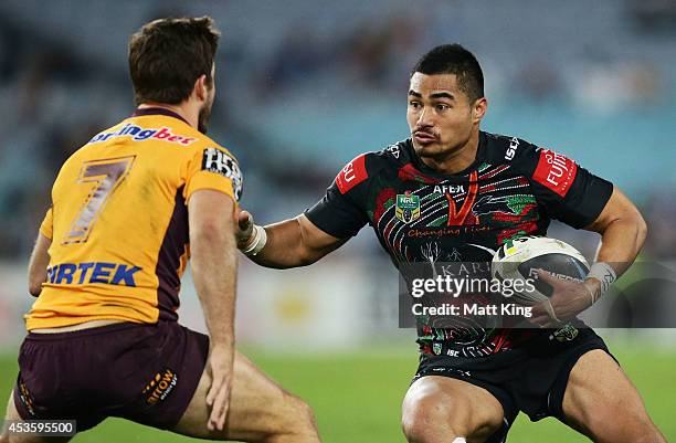 Kirisome Auva'a of the Rabbitohs takes on the defence during the round 23 NRL match between the South Sydney Rabbitohs and the Brisbane Broncos at...