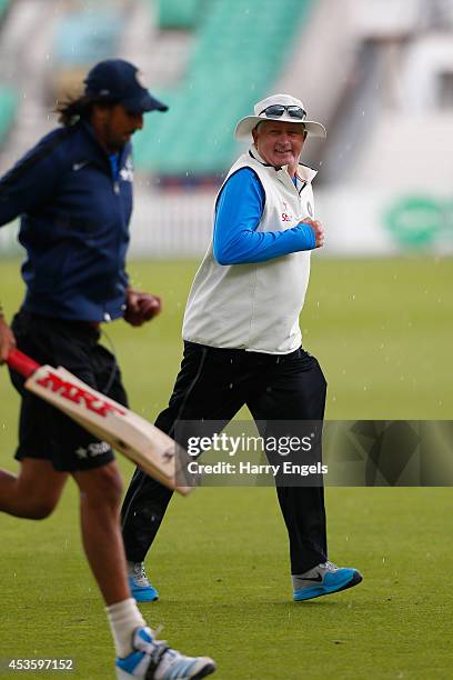 India head coach Duncan Fletcher runs off the field as rain halts practice during an India Nets Session at The Kia Oval on August 14, 2014 in London,...