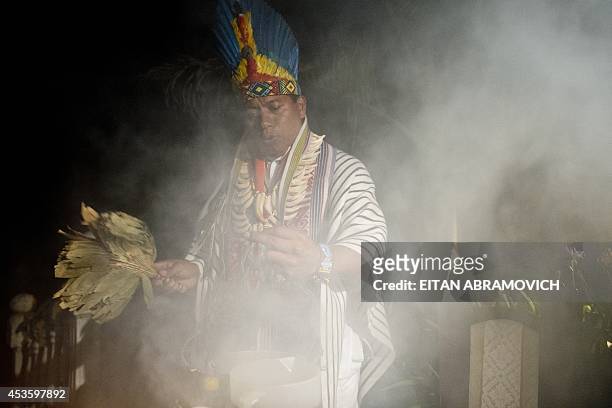 Picture taken on August 9, 2014 of a healer starting a Yage ceremony in La Calera, Cundinamarca department, Colombia. Yage, a mixture of the...
