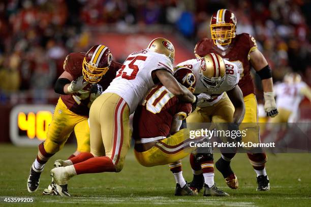 Robert Griffin III of the Washington Redskins is sacked in the fourth quarter of an NFL game against the San Francisco 49ers at FedExField on...