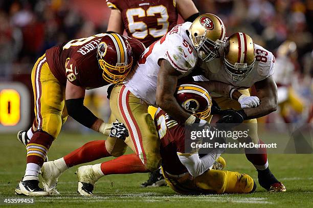 Robert Griffin III of the Washington Redskins is sacked in the fourth quarter of an NFL game against the San Francisco 49ers at FedExField on...