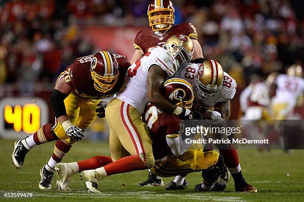 Robert Griffin III of the Washington Redskins is sacked in the fourth quarter of an NFL game against the San Francisco 49ers at FedExField on...