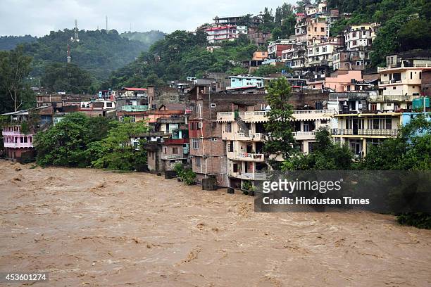 Flood in Sukheti river after heavy rains on August 14, 2014 in Mandi, India. Three persons were washed away by strong water current as rains wreaked...