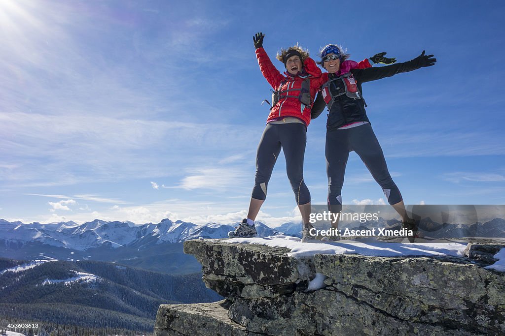 Two ladies celebrate success together on mt summit